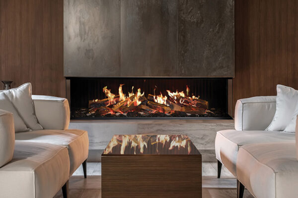 Fancy modern room with a burning fireplace, wooden wall and a tiled floor. There is a glossy table with sofas with pillows, glass stand with vases, black bag with firewood, speaker. Horizontal.